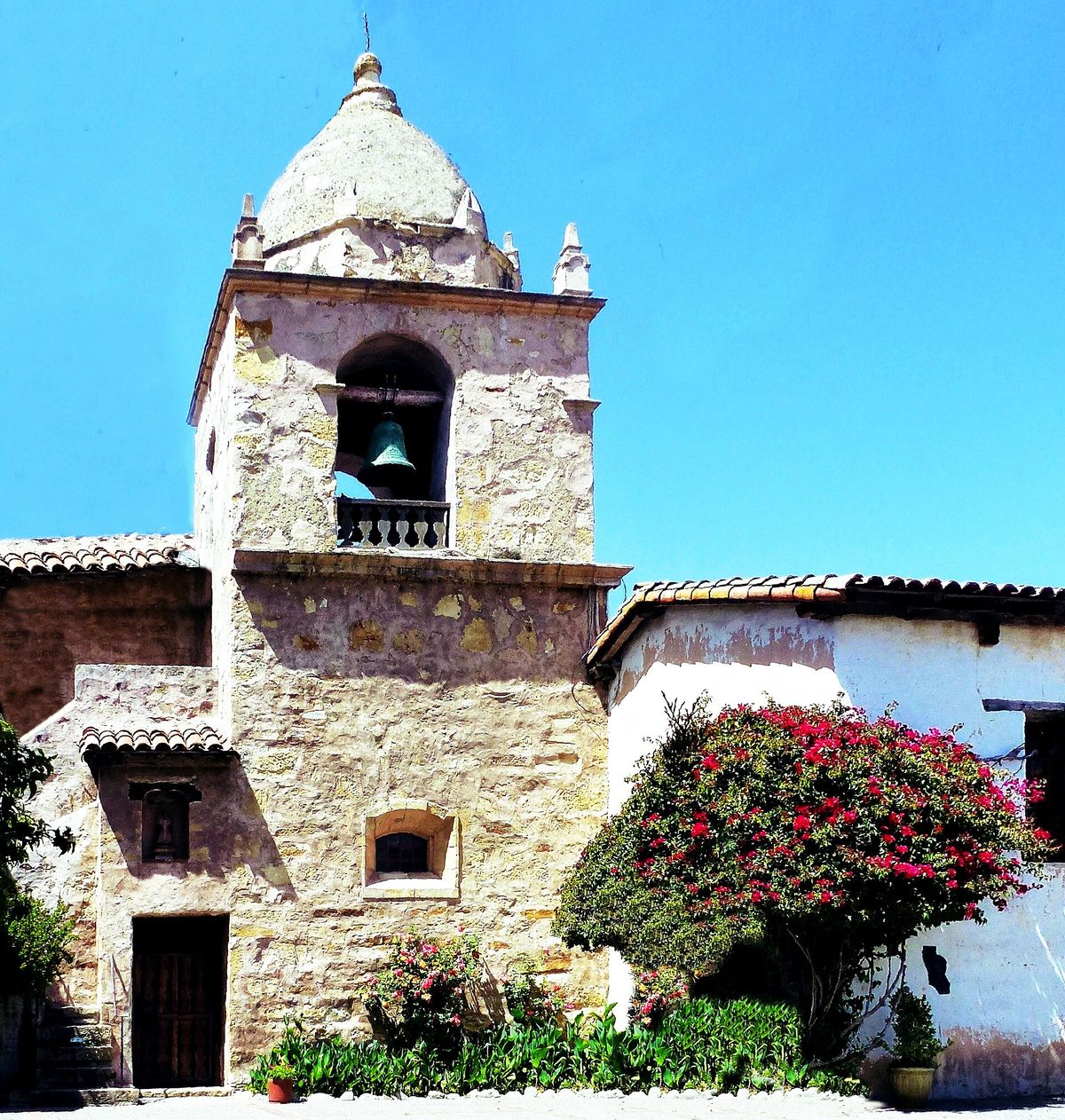 The bell tower of Carmel Mission seen from the courtyard